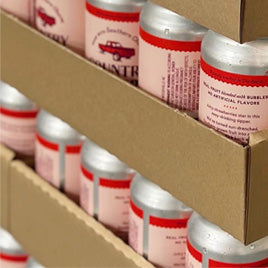 Cans of Country Water in cardboard pallets